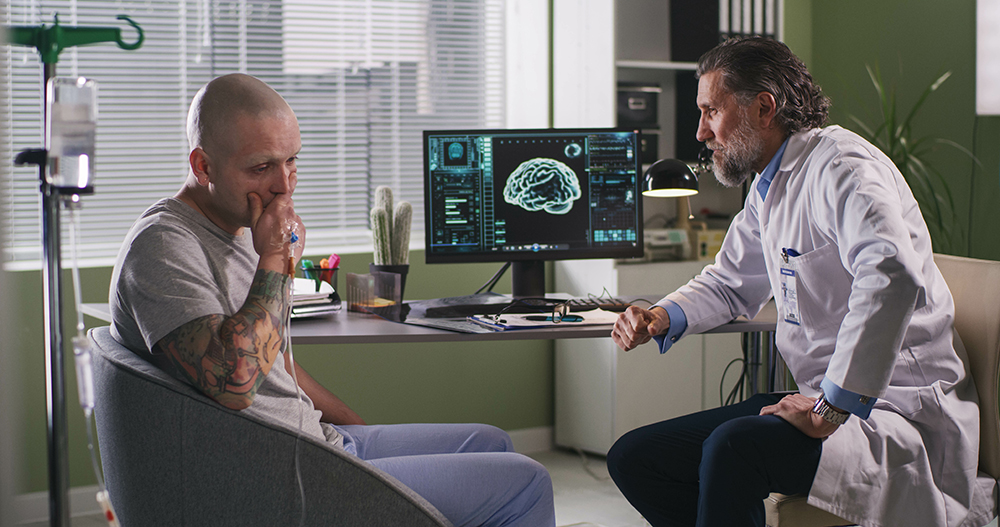 doctor and patient sitting in front of a computer